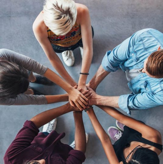 exam preparation students joining hands symbolizing unity and teamwork